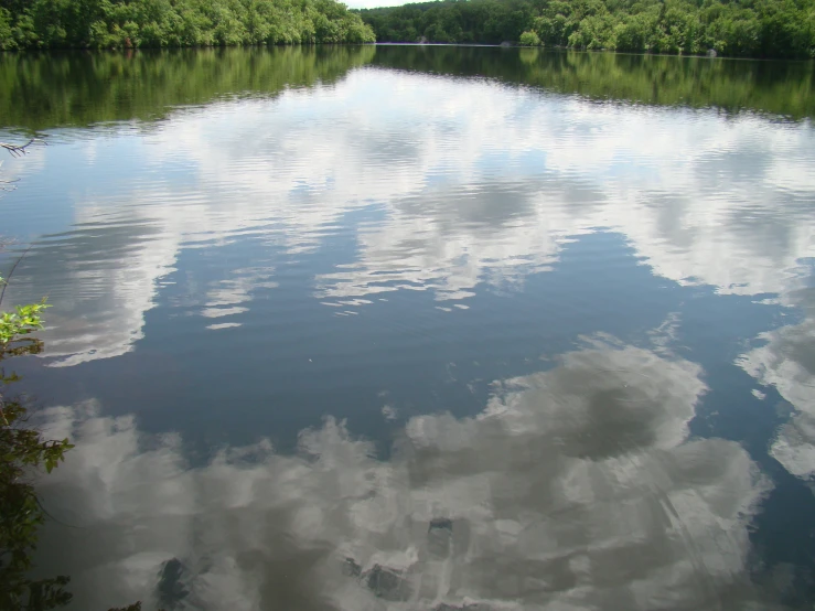 a very pretty blue sky and clouds in a lake