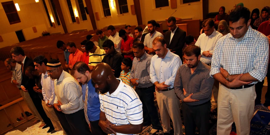 several men gather together while someone prepares to use their phone