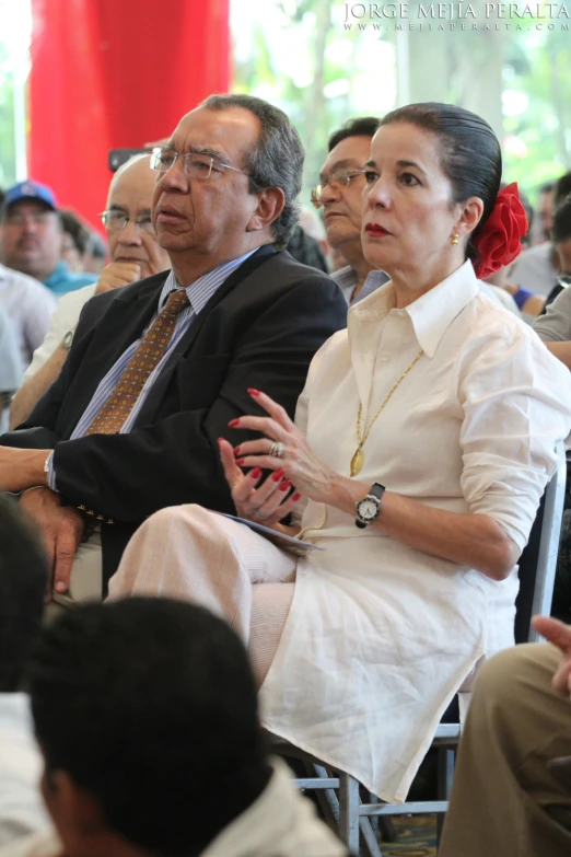 a man sitting in front of another people with a woman on his lap