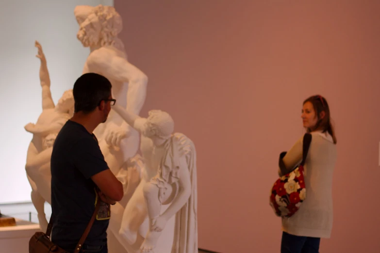 two people in an art museum, one with a camera