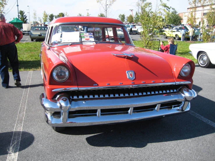 a vintage car is parked in a parking lot