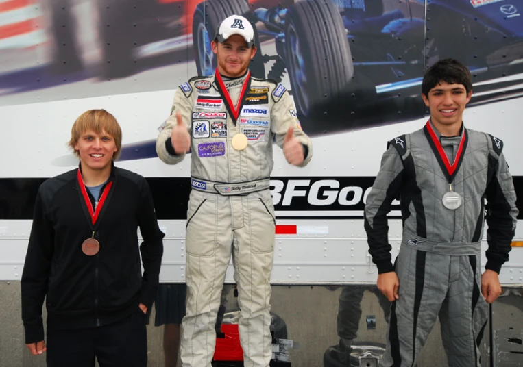a man standing on a winners podium with three boys