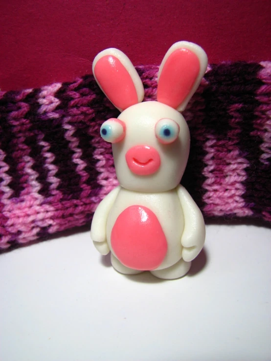 a toy pig with bright pink ears and a nose
