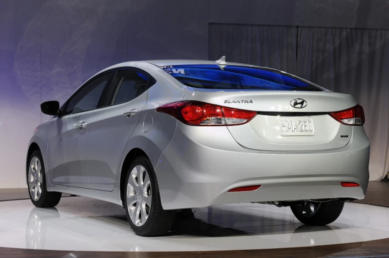 a silver car on display with black accents