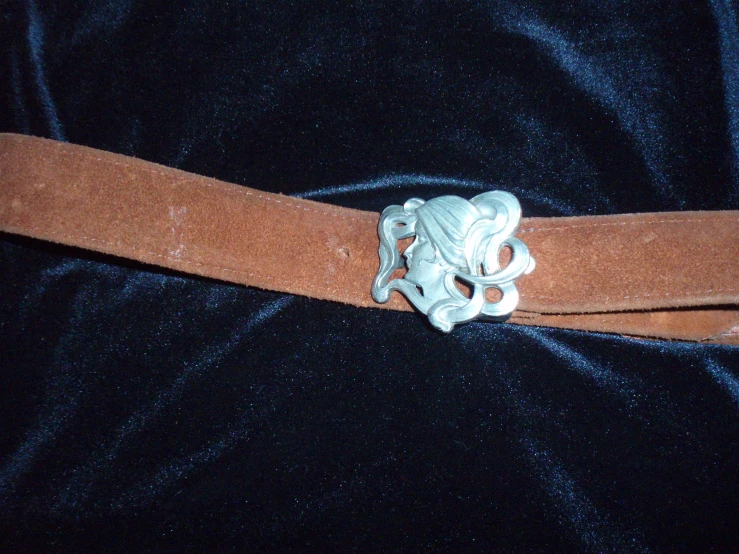 a woman's belt covered in an intricate brooch