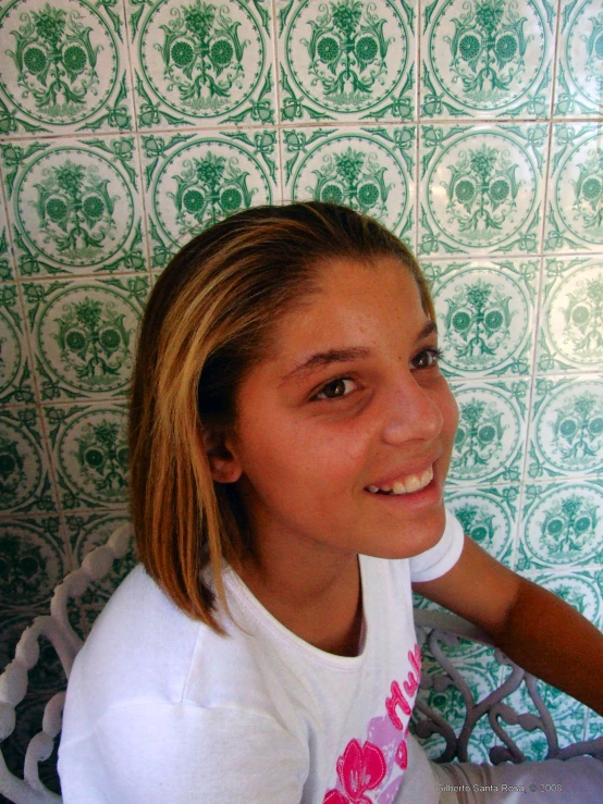 a girl posing for the camera and smiling