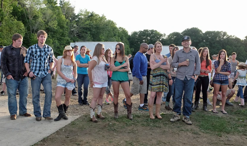 a group of young people standing on the side of a road