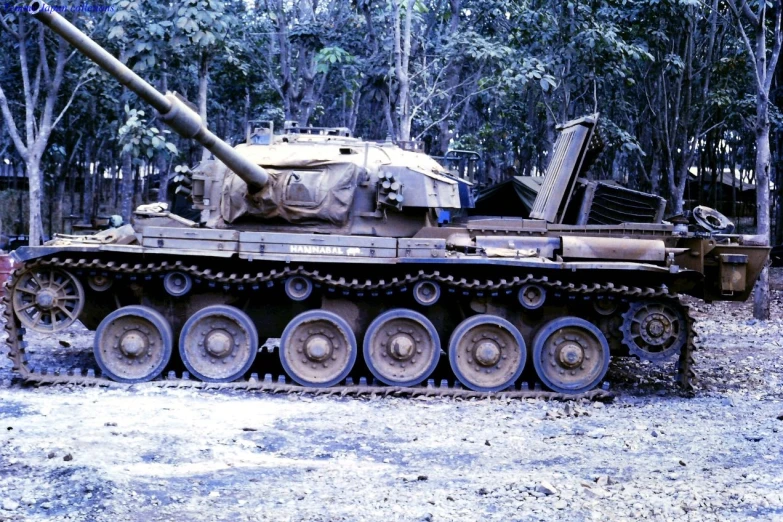 an old, abandoned, tank that looks dirty in the mud