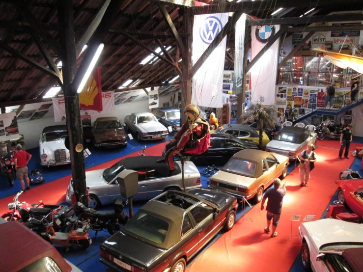 several classic cars on display at an auto show