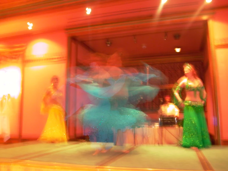 three women dancing around in a dance performance