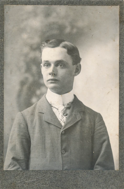 a black and white pograph of a young man in a suit