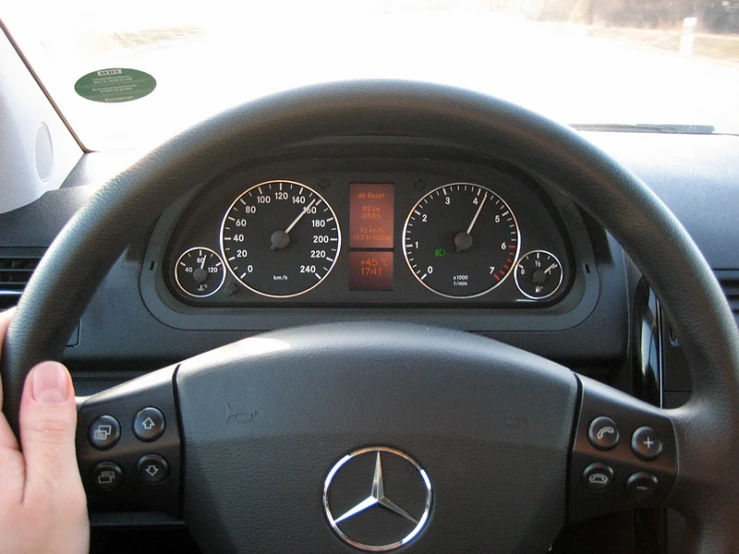 a mercedes steering wheel with a cluster of gauges