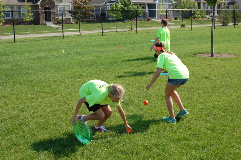 two s are trying to pull on tennis balls