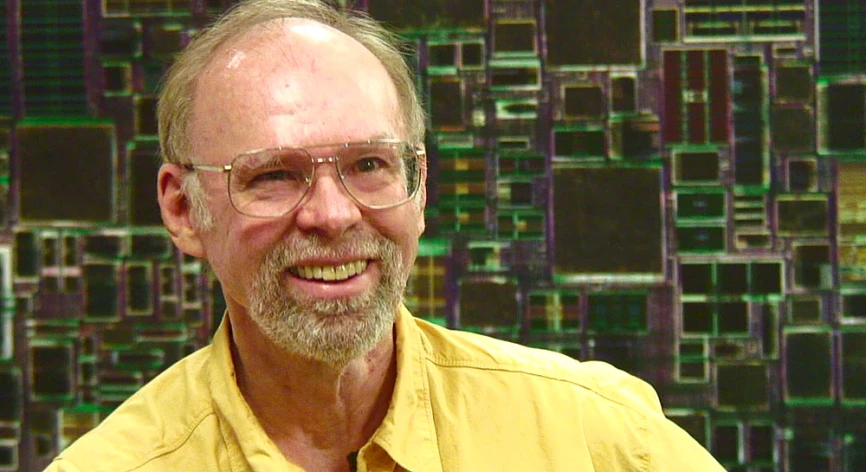 an older man is smiling with square and squares in the background