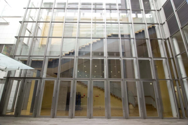 people are walking in an entrance way to a modern building