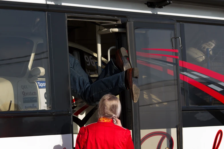 the person is standing up by the door of a bus