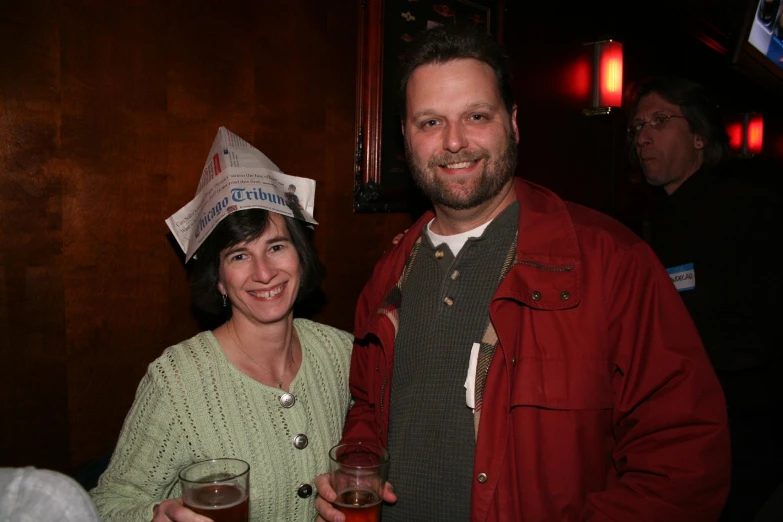 the man and woman are smiling while holding their wine glasses