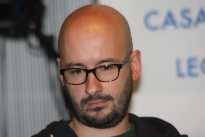 a man with an extra bald head and glasses on