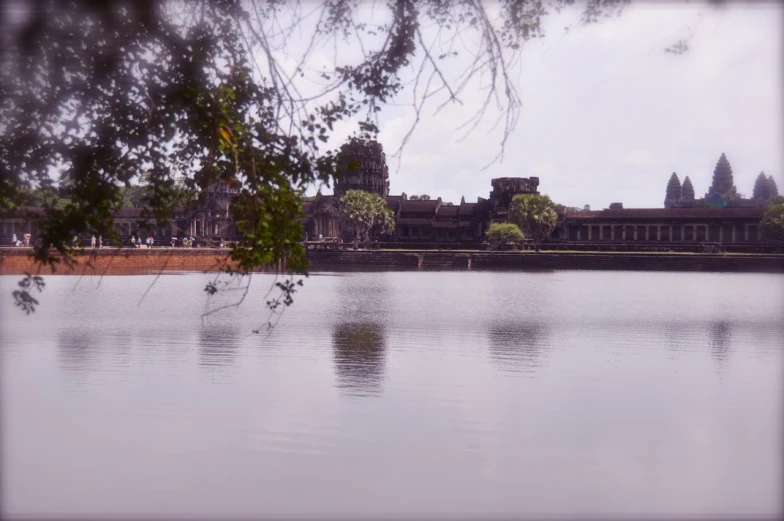 a picture of a water pond with many buildings around