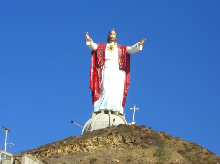 the image is of the jesus statue on top of the hill