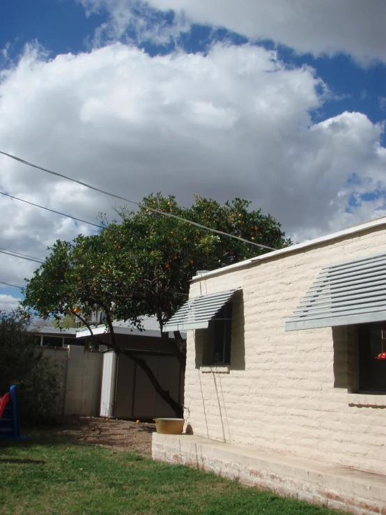 a house with an apple tree next to it