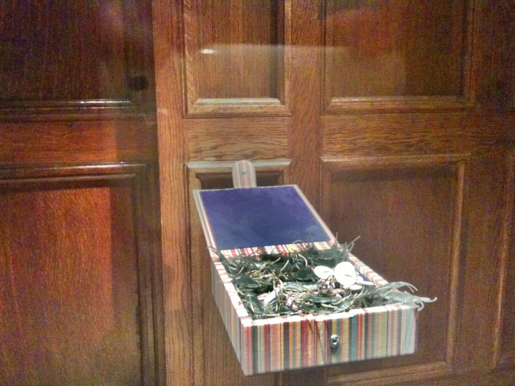 a box with many pieces of wrapping sits in front of a door