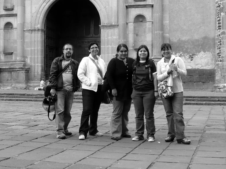 a group of people standing in front of a large building