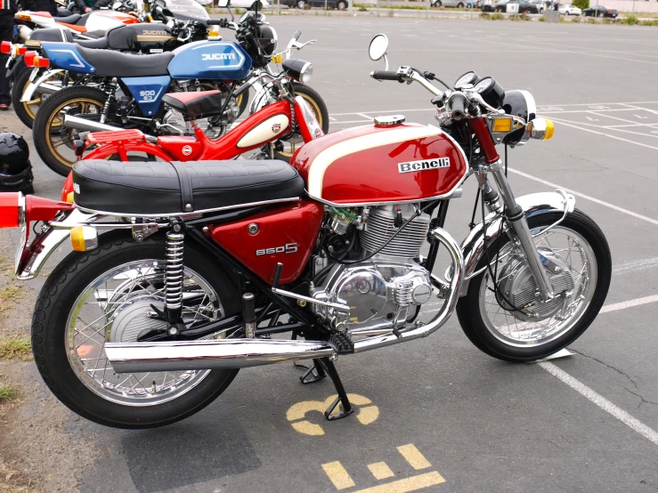 two motorcycles are parked in an empty lot