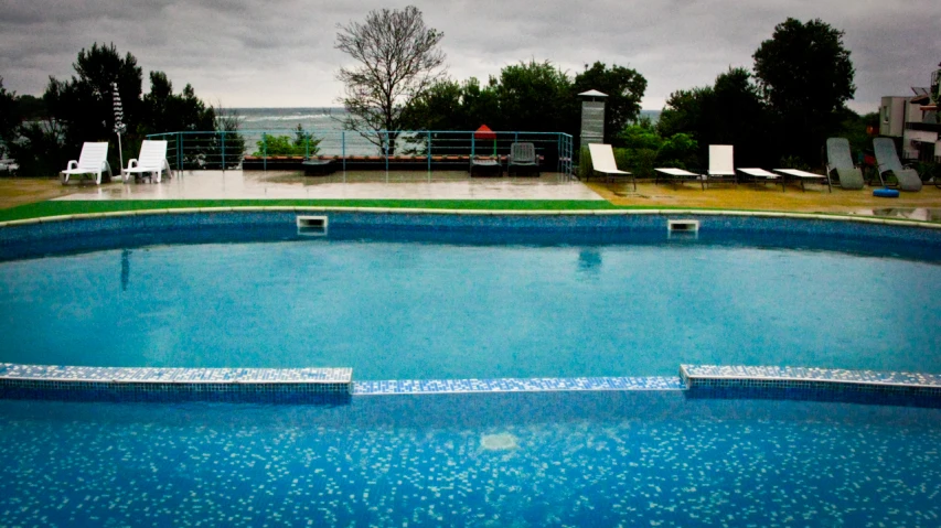 there is a large empty swimming pool in the yard