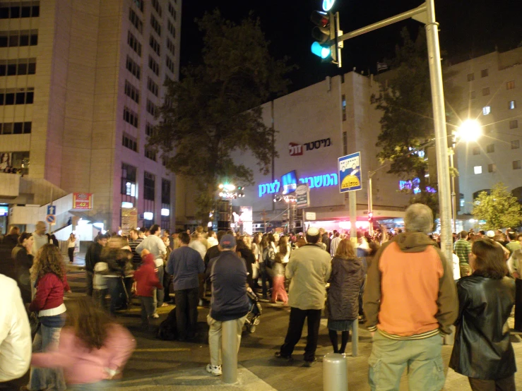 large group of people standing in front of a store