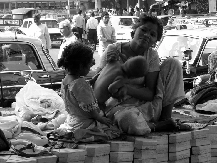 an old man sitting next to a child on a street