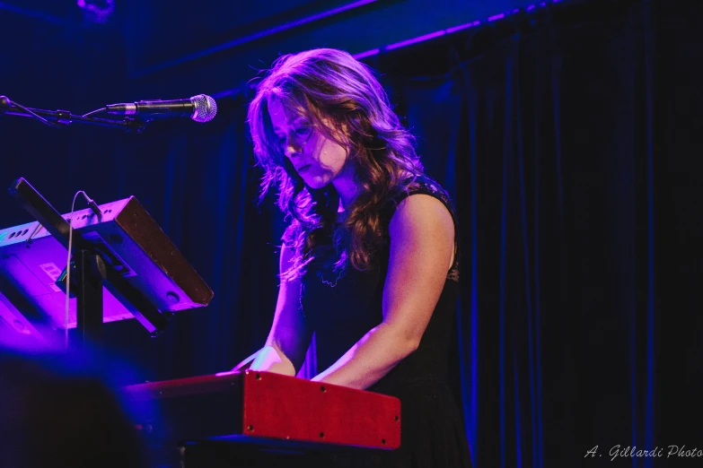 the young woman is standing in front of the microphone