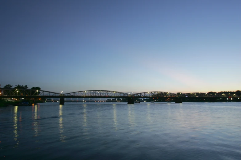 a large bridge over a lake with light reflections