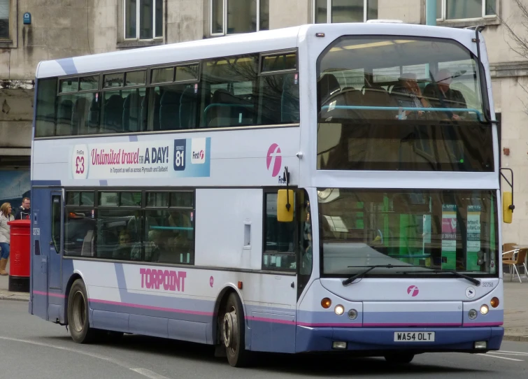 a double decker bus on the street next to the curb