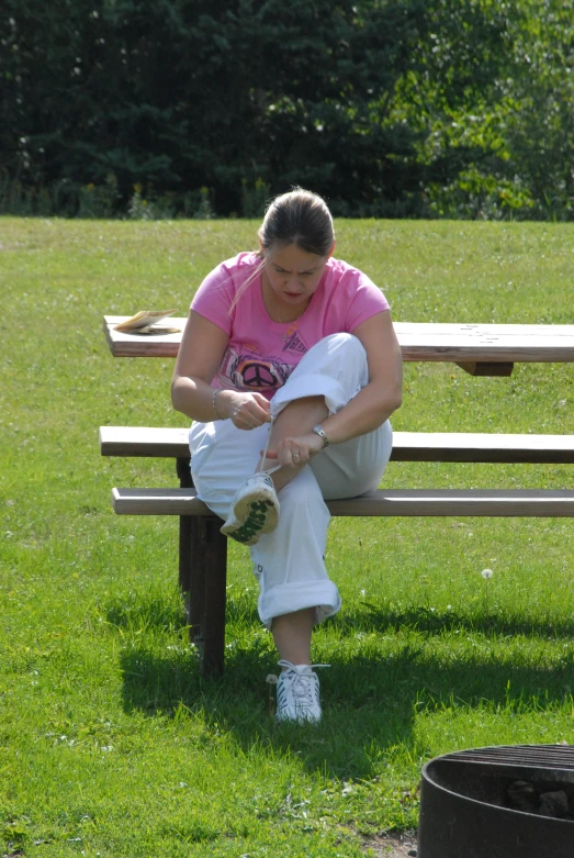 a woman is sitting on a park bench