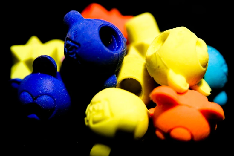 several colorful rubber toy toys in the dark