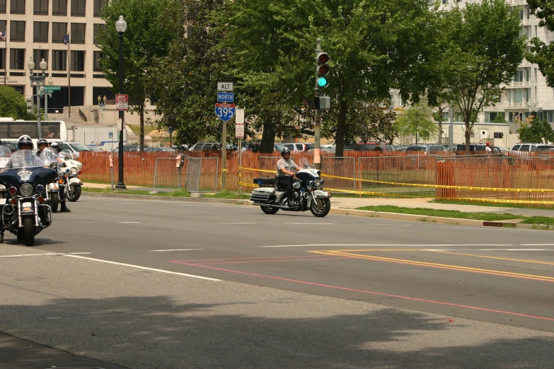 police officers riding their motorcycles on the road
