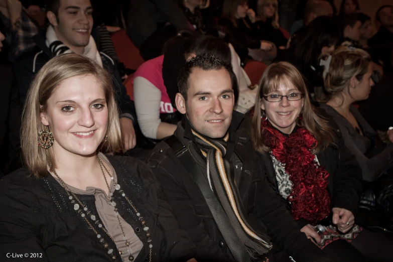 two people sitting next to each other and smiling