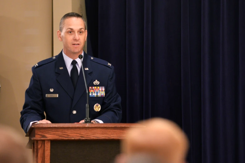 a person in a uniform standing behind a podium