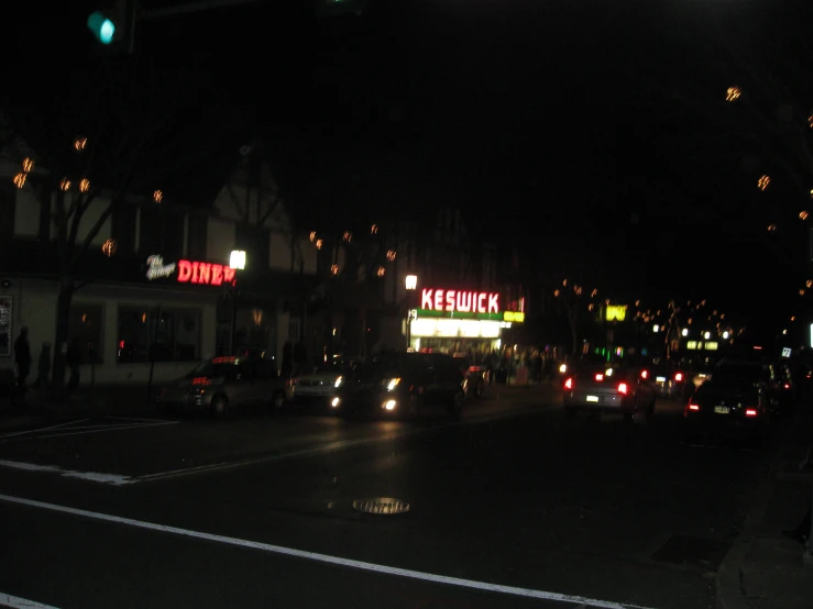 car headlights are visible on a city street at night