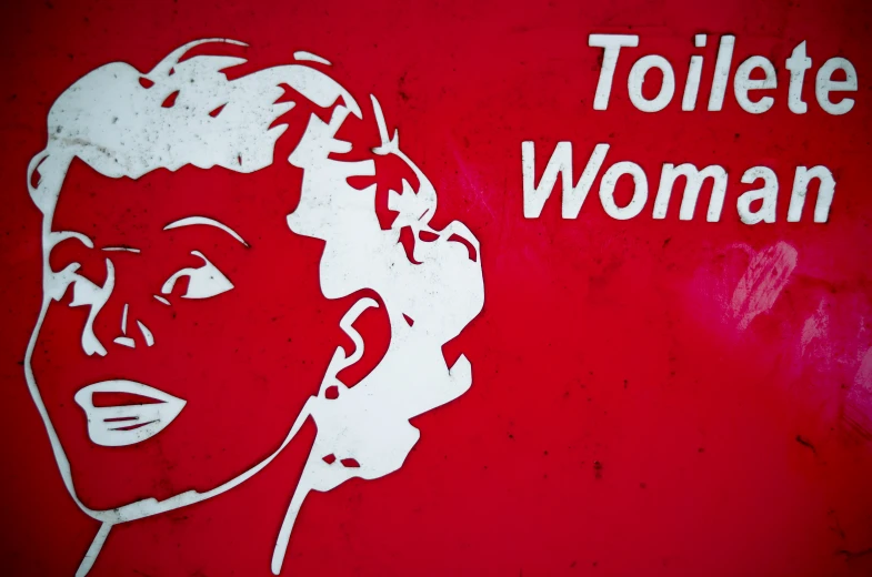 a close up of a painted sign with a woman's face on the side