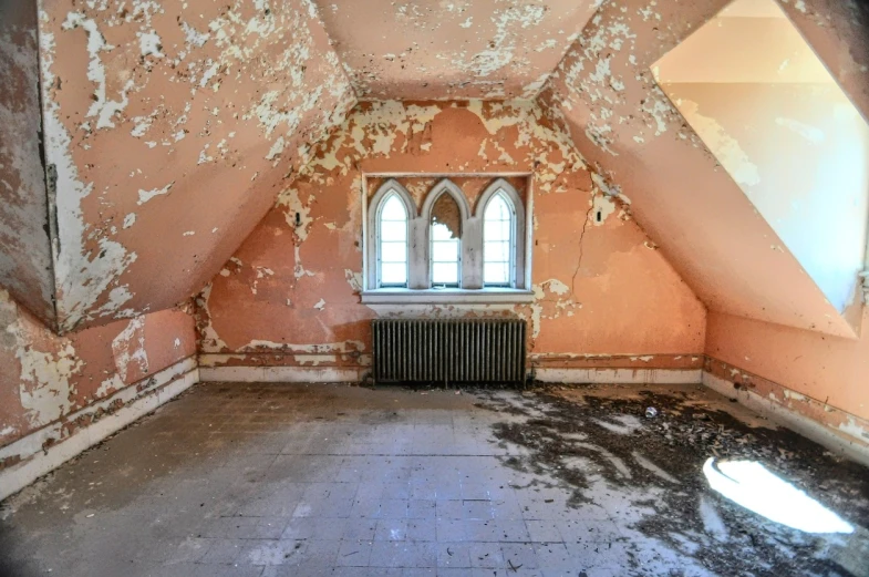 an empty attic is used as a room with a window