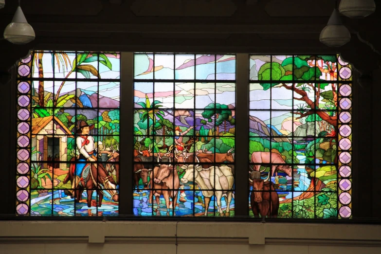 colorful stained glass windows in a building with a horse and man on the background