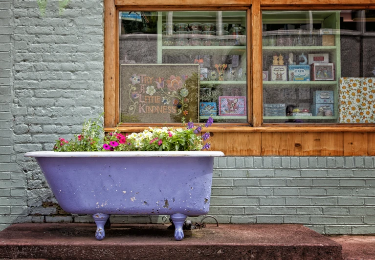 a planter is filled with flowers by the window