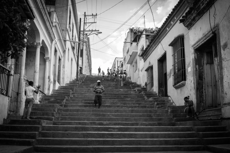 several people climbing the steps near an alley way