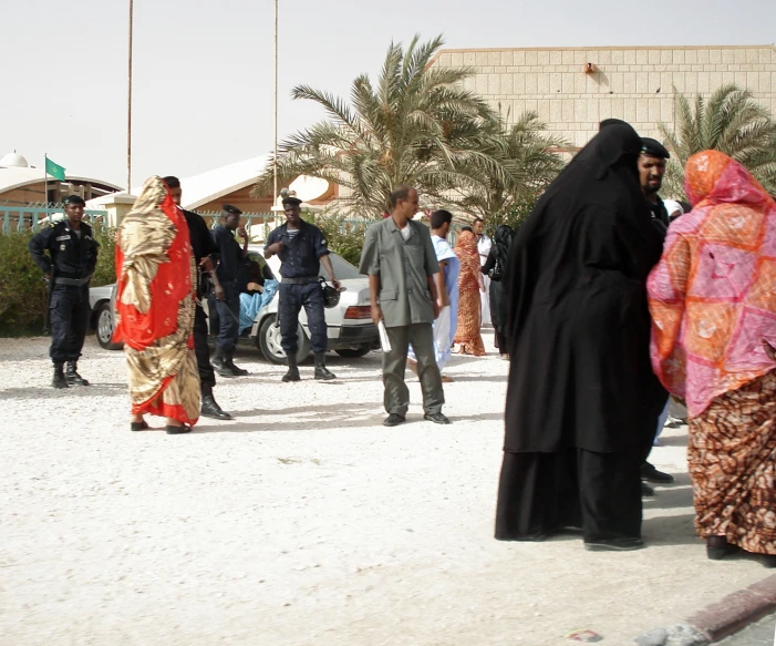 people standing in line in front of some buildings