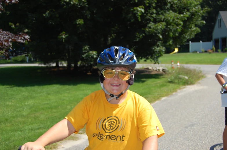 a  in yellow shirt on bicycle