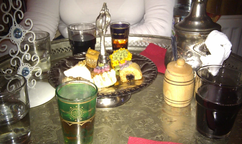 a tray filled with pastries and drinks on a table