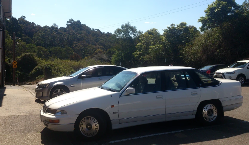 cars parked next to each other at a parking space