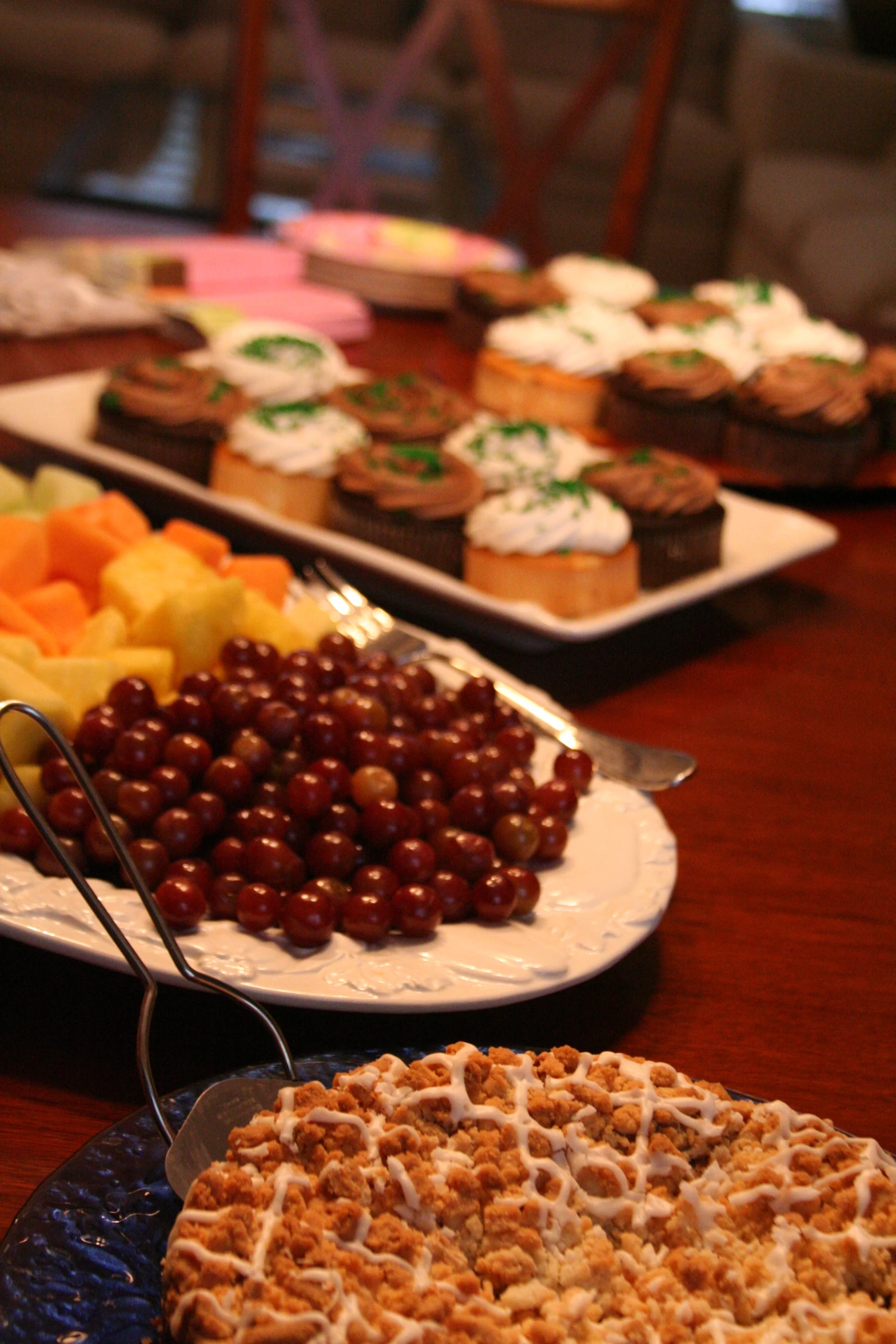 plates of food, including fruit, are on the table